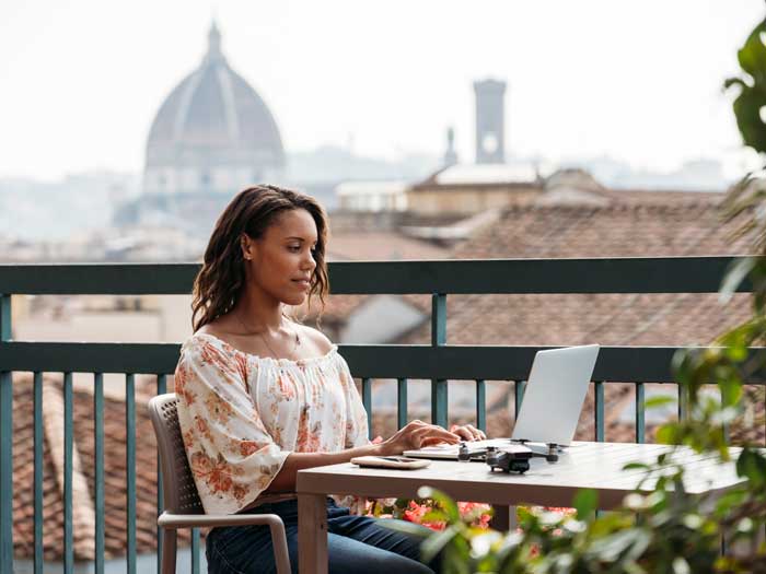 Young woman using a laptop in Florence, Italy